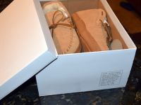 The shoes plus the Box with the California Prop 65 Warning label